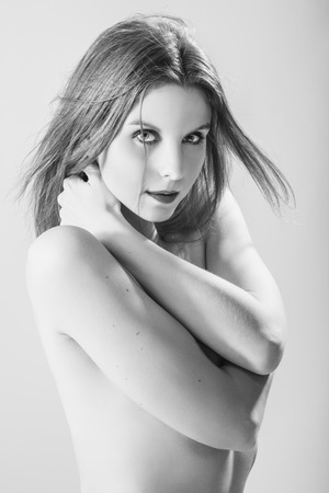 portrait of young beautiful naked pensive woman, monochrome imageの写真素材