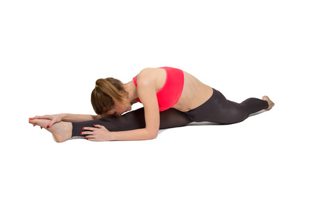 young fitness woman stretching isolated on white backgroundの写真素材