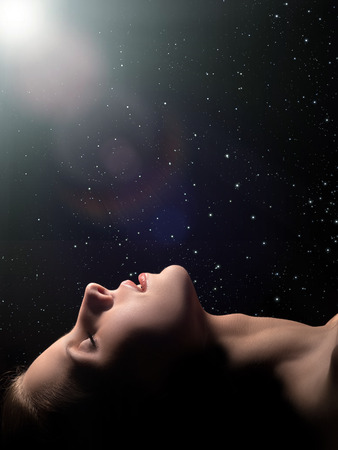 sensual sleeping woman profile on black backgroundの写真素材