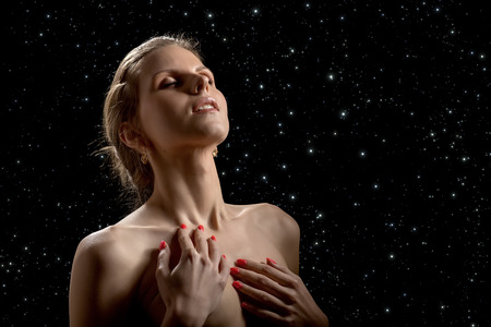 sensual aroused woman on stars skyの写真素材