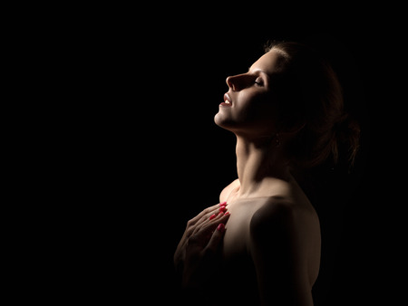 sensual aroused woman profile in darkの写真素材