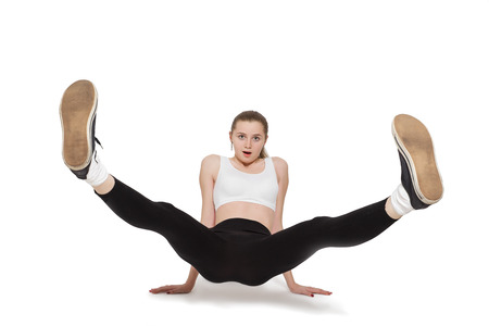 fun woman with raised feet on white background isolatedの写真素材