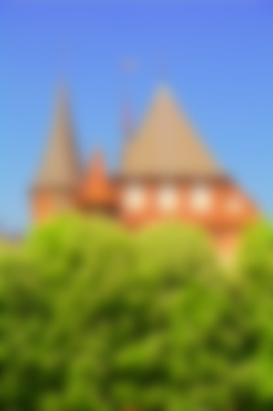 gothic towers over green trees blurred backgroundの写真素材