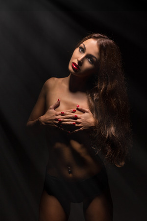 luxury woman cover her body in light raysの写真素材