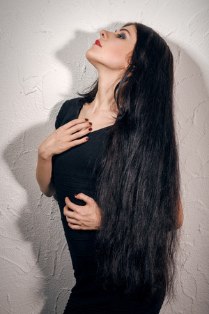aroused woman with long hair and shadow profileの写真素材