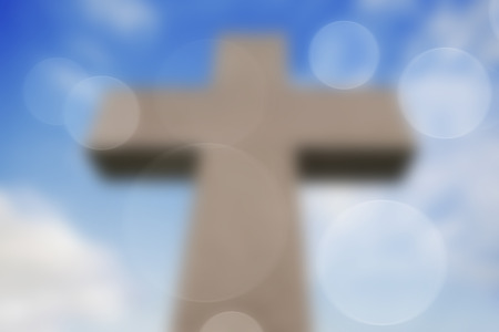 Big Stone Cross on Sky Blurred Backgroundの写真素材