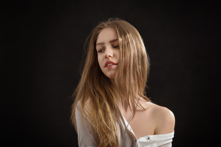 sensual girl with long hair on black backgroundの写真素材