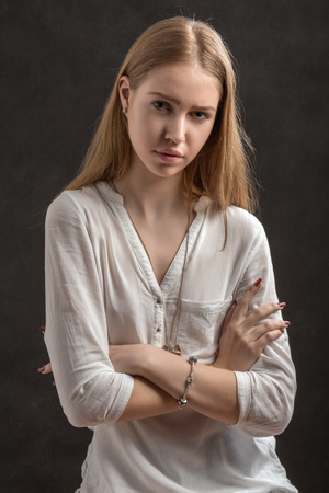 serious blond woman on black backgroundの写真素材