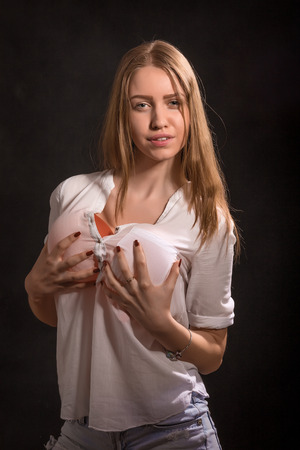 sensual pretty girl shows big breasts on black backgroundの写真素材