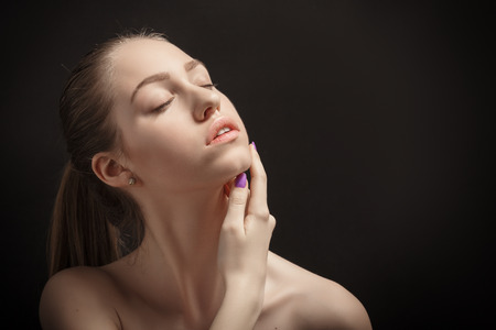 pretty sensual woman with bare shoulders on black backgroundの写真素材