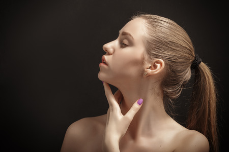sensual blond girl profile on black backgroundの写真素材
