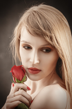 luxury girl with long hair and red roseの写真素材