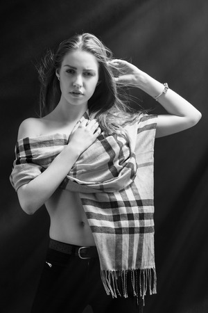 sensual girl posing in scarf on black backgroundの写真素材