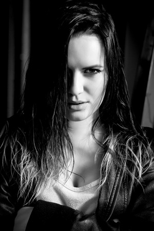 sensual woman in leather jacket looking at camera monochromeの写真素材