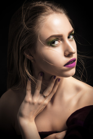 pretty girl with bright makeup on black backgroundの写真素材