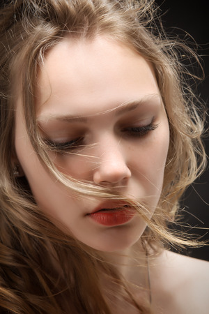 woman with long hair portrait on black backgroundの写真素材