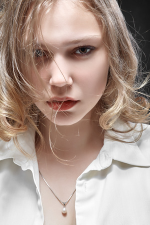 sad woman portrait on black backgroundの写真素材