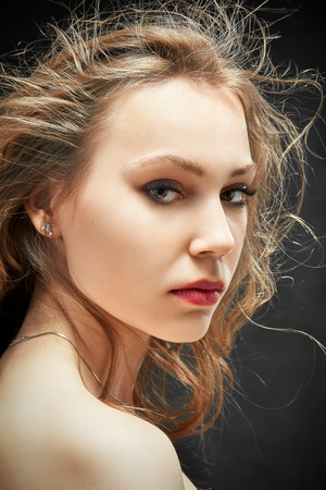 beautiful woman looking over bared shoulderの写真素材