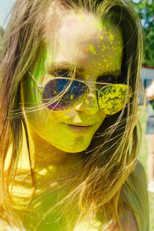 girl with multicolored face at Holi Festival