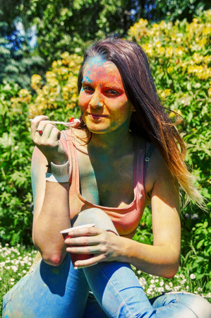 girl eating ice-cream at Holi Festivalの写真素材
