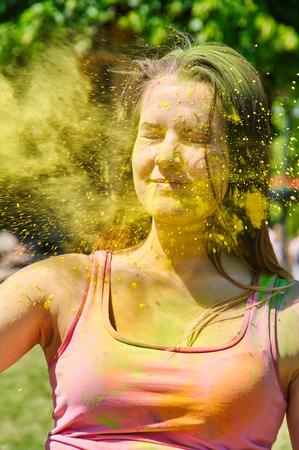 happy girl has paint on her face at Holi Festivalの写真素材