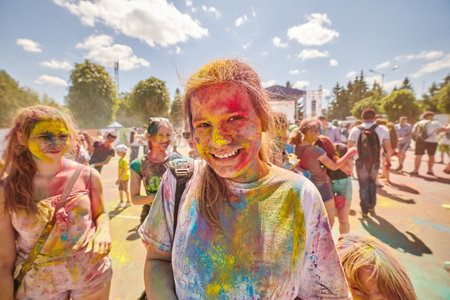 KALININGRAD, RUSSIA - JUNE 12, 2015: People with painted faces during the Holi Festival of Colors. Holi is a festival celebrated as a festival of coloursのeditorial素材