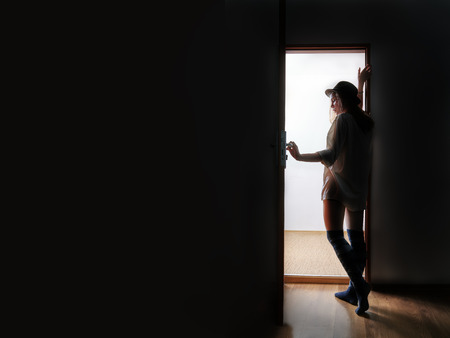 woman enter to white space from dark, image with copyspaceの写真素材
