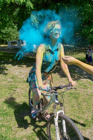 KALININGRAD, RUSSIA - JUNE 06, 2015: Woman throwing cyan holi powder during the Holi Festival of Colors. Holi is a festival celebrated as a festival of coloursのeditorial素材