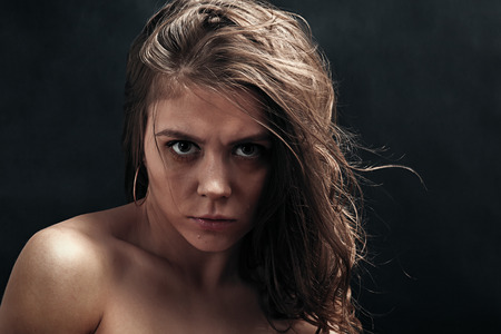 angry woman portrait on black backgroundの写真素材