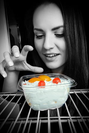 woman take night dessert in refrigeratorの写真素材
