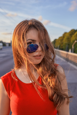girl with long hair at sunset in cityの写真素材