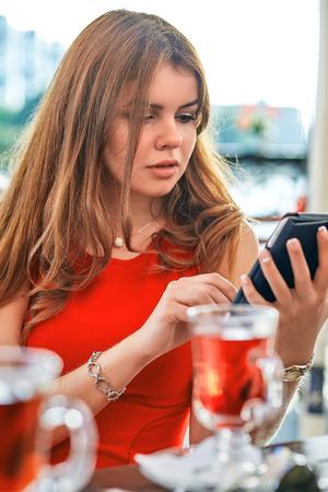 beautiful woman with tablet in street cafeの写真素材