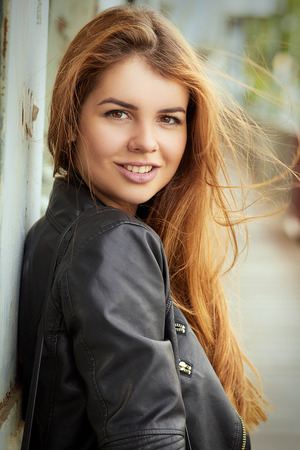 happy woman with long red hair portrait, toned imageの写真素材
