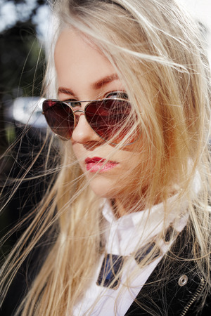 serious woman looking over sunglassesの写真素材