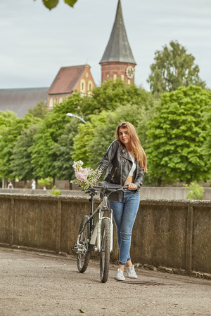 attractive woman with bike in cityの写真素材