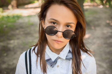 pretty sad girl hipster looking at cameraの写真素材