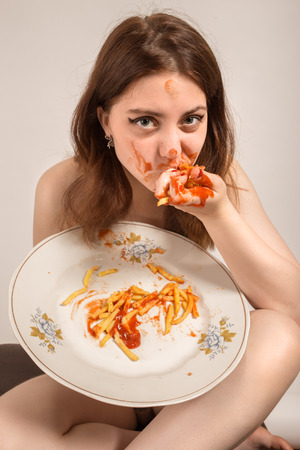 Fun Woman Eats French Friesの写真素材