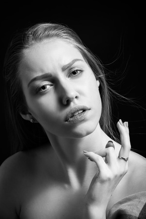 pretty sensual woman with bare shoulders on black background monochromeの写真素材