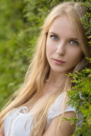attractive sad blond young woman looking at cameraの写真素材