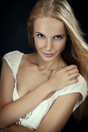 Beautiful Young Blond Woman on black backgroundの写真素材