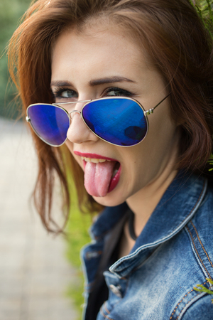 fun young woman showing her tongueの写真素材