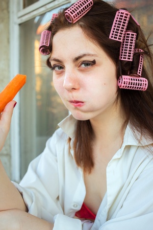 fun girl eating carrotの写真素材