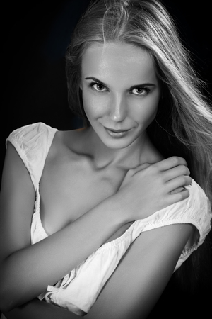 Beautiful Young Blond Woman on black background, monochromeの写真素材