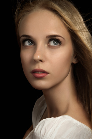 luxury scared blond girl on black backgroundの写真素材