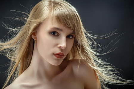 luxury woman with flying hair on black backgroundの写真素材