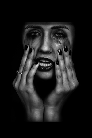 scared crying woman in the darkの写真素材