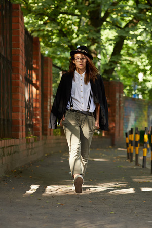 serious girl hipster walking on streetの写真素材