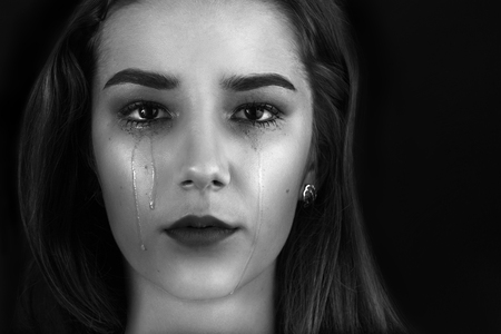 beautiful woman crying on black background, monochromeの写真素材