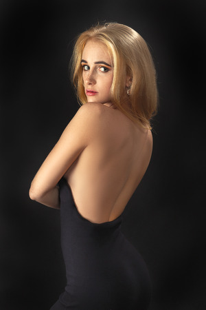 pretty blond woman looking back over shoulderの写真素材