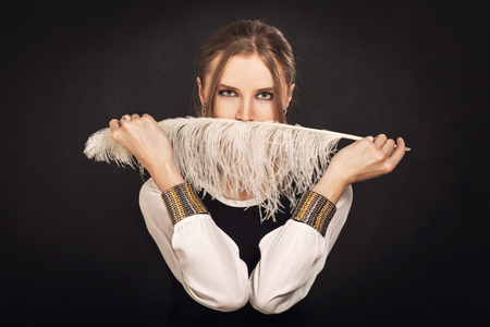 woman cover her face with featherの写真素材